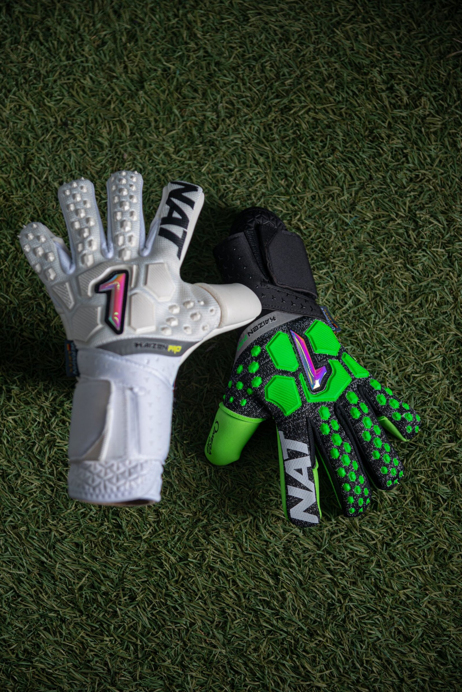 A close-up shot of vibrant football gloves on lush green grass.